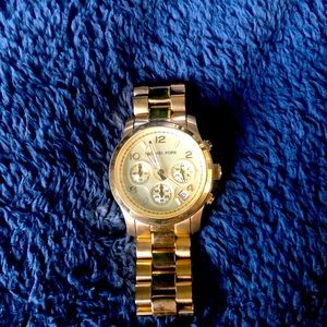 Gold large Michael Kors watch.